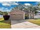 Charming single-story home featuring a well-manicured lawn, inviting curb appeal, and a two car garage at 2329 Towering Oaks Cir, Seffner, FL 33584