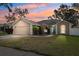 Charming single-story home showcasing a well-maintained lawn and a stylish blue front door at 2329 Towering Oaks Cir, Seffner, FL 33584