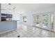 Bright kitchen features gray cabinetry, a breakfast bar, and French doors leading to the outside at 2329 Towering Oaks Cir, Seffner, FL 33584