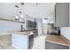 Kitchen featuring gray cabinets, stainless steel appliances and breakfast bar at 2329 Towering Oaks Cir, Seffner, FL 33584
