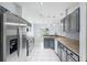 Kitchen featuring gray cabinets, stainless steel appliances, and bar seating at 2329 Towering Oaks Cir, Seffner, FL 33584
