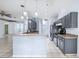 Open concept kitchen featuring gray cabinetry, stainless steel appliances and breakfast bar at 2329 Towering Oaks Cir, Seffner, FL 33584