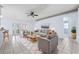 Inviting living room featuring tile flooring, a ceiling fan, and comfortable seating at 2329 Towering Oaks Cir, Seffner, FL 33584