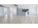Large living space with tile flooring and an open floor plan connecting to the kitchen area at 2329 Towering Oaks Cir, Seffner, FL 33584