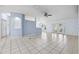 Expansive living space features tile flooring, French doors, and seamless access to the kitchen and dining areas at 2329 Towering Oaks Cir, Seffner, FL 33584