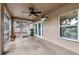 Covered patio with ceiling fan, double doors to yard, and a large window at 2329 Towering Oaks Cir, Seffner, FL 33584