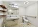 Bathroom with grab bar, wall mirror cabinet, toilet, and tiled floor at 36750 Us 19 N # 08102, Palm Harbor, FL 34684