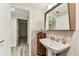 Bathroom featuring pedestal sink and tile accent wall at 36750 Us 19 N # 08102, Palm Harbor, FL 34684