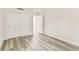Unfurnished bedroom shows light-colored laminate flooring and a white sliding-door closet at 36750 Us 19 N # 08102, Palm Harbor, FL 34684