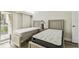 Bedroom featuring two beds with neutral paint and natural lighting at 36750 Us 19 N # 08102, Palm Harbor, FL 34684