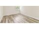 This bedroom boasts light-colored laminate flooring and a bright window with white shutters at 36750 Us 19 N # 08102, Palm Harbor, FL 34684
