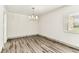 Bright living room with wood-look floors, white walls and a chandelier at 36750 Us 19 N # 08102, Palm Harbor, FL 34684