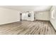 Open living room featuring plank flooring, neutral walls, and abundant natural light at 36750 Us 19 N # 08102, Palm Harbor, FL 34684