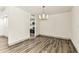 Bright living room with wood-look floors, white walls and a chandelier at 36750 Us 19 N # 08102, Palm Harbor, FL 34684
