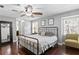 Cozy bedroom boasts natural light, ceiling fan, and wood flooring, creating a serene retreat at 4506 W Beachway Dr, Tampa, FL 33609