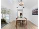 Dining room with hardwood floors, bright lighting, and sliding glass doors at 4506 W Beachway Dr, Tampa, FL 33609