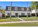 Charming two-story home with a well-manicured lawn and classic architectural details at 4506 W Beachway Dr, Tampa, FL 33609