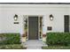 Elegant front entrance with decorative lighting and landscaping at 4506 W Beachway Dr, Tampa, FL 33609