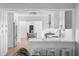 Bright kitchen with breakfast bar, modern white cabinets, and stainless steel refrigerator at 4506 W Beachway Dr, Tampa, FL 33609