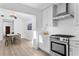 Bright kitchen with modern stainless steel appliances, white subway tile backsplash, and access to dining room at 4506 W Beachway Dr, Tampa, FL 33609