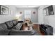 Living room with dark leather sofa, wood floors, neutral paint and a large window at 4506 W Beachway Dr, Tampa, FL 33609