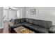 Inviting living room features a comfortable black sectional, hardwood floors, and abundant natural light at 4506 W Beachway Dr, Tampa, FL 33609