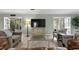Comfortable living room featuring stylish furniture, a large TV, and an open layout perfect for modern living at 4506 W Beachway Dr, Tampa, FL 33609
