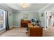 Bright home office featuring a classic piano, desk, and large window at 4506 W Beachway Dr, Tampa, FL 33609
