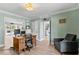 Home office with wood desk and chair, leading to additional rooms at 4506 W Beachway Dr, Tampa, FL 33609