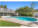 Backyard boasts a sparkling pool, lush tropical landscaping, and an inviting patio area at 4506 W Beachway Dr, Tampa, FL 33609