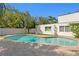The backyard features a pristine pool, brick-paved patio, and privacy fencing at 4506 W Beachway Dr, Tampa, FL 33609
