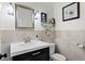 Elegant powder room featuring a modern sink, stylish fixtures, and tastefully decorated walls at 4506 W Beachway Dr, Tampa, FL 33609