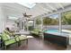 Bright sunroom with skylights, comfortable seating, and a view of the pool at 4506 W Beachway Dr, Tampa, FL 33609