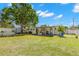 Spacious backyard with lawn, patio, and tropical landscaping at 501 61St Ne Ave, St Petersburg, FL 33703