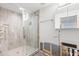 Bathroom with wood-look tiled shower and glass door, featuring unfinished wall renovations at 501 61St Ne Ave, St Petersburg, FL 33703