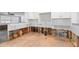Partially demoed kitchen with white cabinets, subway tile backsplash, and unfinished floors at 501 61St Ne Ave, St Petersburg, FL 33703