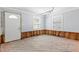 Unfinished room with door, wood floor, two windows, and exposed studs ready for renovation at 501 61St Ne Ave, St Petersburg, FL 33703