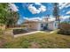 This backyard features a covered patio, a fenced yard, and green grass at 5411 96Th N Ter, Pinellas Park, FL 33782
