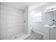 This bathroom features new tile in the walk-in shower, a vanity, and a window at 5411 96Th N Ter, Pinellas Park, FL 33782