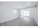 This bedroom features gray wood floors, a window, and a double-door closet at 5411 96Th N Ter, Pinellas Park, FL 33782