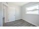 This bedroom features a window and wood floors and opens up to the hallway at 5411 96Th N Ter, Pinellas Park, FL 33782