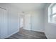 This bedroom features a closet, gray wood floors, and a window at 5411 96Th N Ter, Pinellas Park, FL 33782