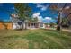 Landscaped front yard with a well-maintained lawn and mature trees surrounding this charming home at 5411 96Th N Ter, Pinellas Park, FL 33782