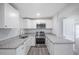 Modern kitchen showcasing stainless steel appliances, granite countertops, and white cabinetry at 5411 96Th N Ter, Pinellas Park, FL 33782