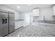 Contemporary kitchen featuring stainless steel appliances, granite countertops, and modern white cabinets at 5411 96Th N Ter, Pinellas Park, FL 33782