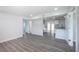Open-concept living space featuring gray floors and a seamless flow into the adjacent kitchen at 5411 96Th N Ter, Pinellas Park, FL 33782