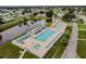 Aerial view of the pool area, including a pool, tables, chairs and umbrellas at 5546 Benton St, Zephyrhills, FL 33542