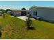 Backyard featuring green grass and a distant view of neighboring homes at 5546 Benton St, Zephyrhills, FL 33542