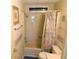Modest bathroom with shower-tub combo and seashell-themed decor at 5546 Benton St, Zephyrhills, FL 33542