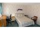 Calm bedroom with floral wallpaper and blue carpet, with desk and good lighting at 5546 Benton St, Zephyrhills, FL 33542